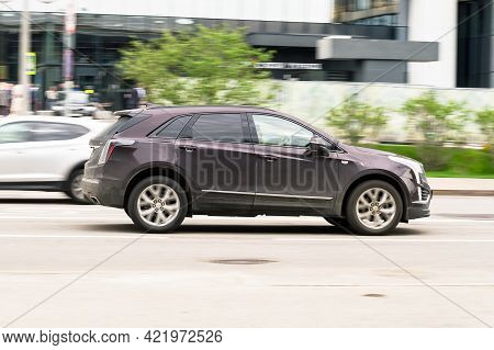 Moscow , Russia - May 2021: Black Color Cadillac Xt5 In Fast Motion On The Street. Premium Suv Fast 