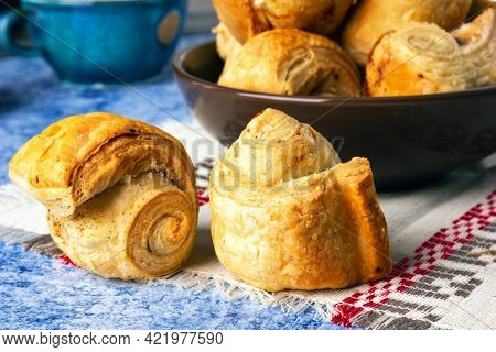 Fresh homemade puff pastry rolls baked with cinnamon. 