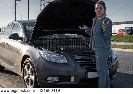 Broken Down Car. Vehicle Engine Motor Problem Concept. Driver Girl Near Open Hood Auto.