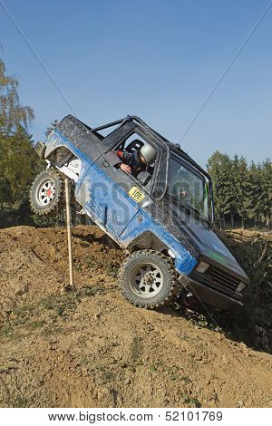 Blue Off-road Car In A Difficult Tarrain. Vertically.