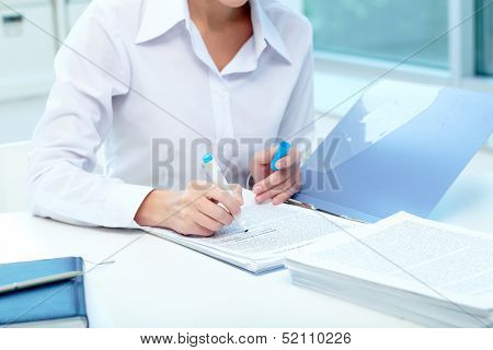 Close-up of young female writing proficiency test