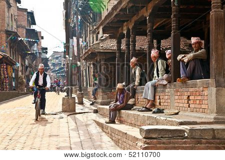BHAKTAPUR - MAY 20 : Unidentified Tharu old men besides the street of Bhaktapur, Nepal on May 20, 2013. Tharu are an ethnic group from west part of Nepal.