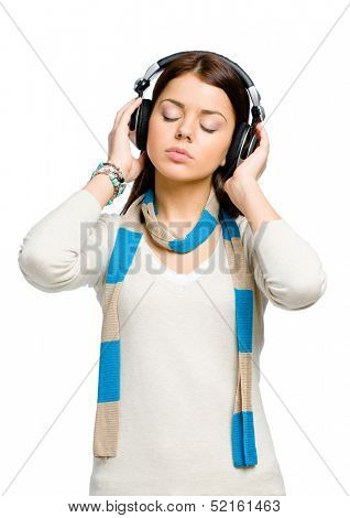 Half-length portrait of teenager with eyes closed listening to music in headphones, isolated on white