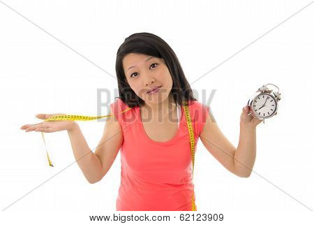 Asian Woman Worried About Starting A Diet Holding Alarm Clock