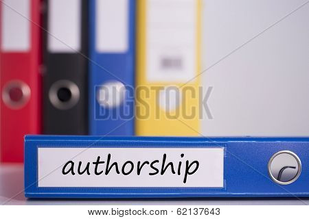 The word authorship on blue business binder