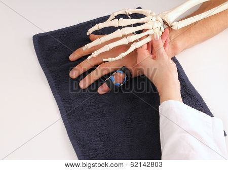 Hand Surgeon With Skeleton Hand At Patient