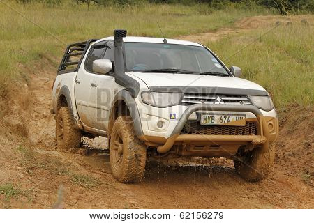 White Toyota Triton Dhd Crossing Mud Obstacle
