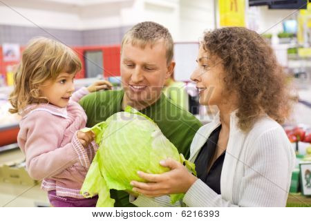 Family With Girl Buy Cabbage In Supermarket