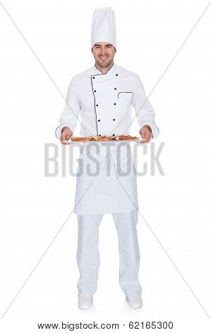 Portrait Of Happy Bakerman With Tray