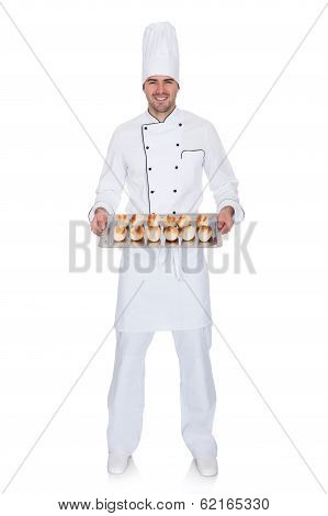 Portrait Of Happy Bakerman With Tray