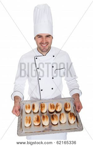 Portrait Of Happy Bakerman With Tray