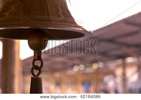 old bell in train station with sunrise light