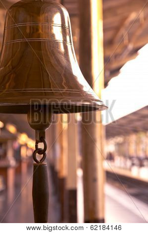 old bell in train station with sunrise light
