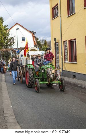 The Carnival  Parade  Moves Through The City Anmd The Tractor Has Horse Heads In Front
