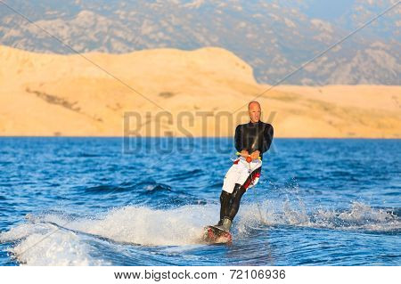 Wakeboarder in sunset.