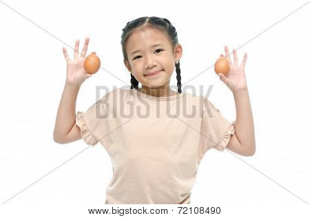 Little asian girl smiiing and holding egg