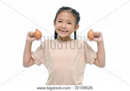 Little asian girl smiiing and holding egg