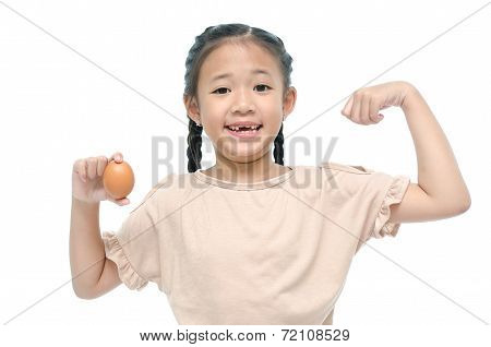 Little asian girl smiiing and holding egg