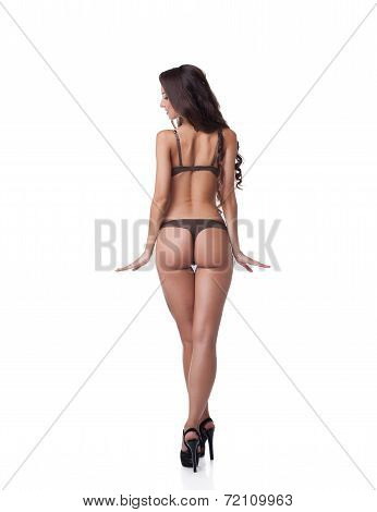 Rear view of slim tanned model with elastic skin