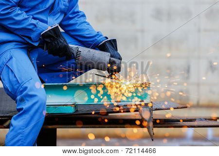 Worker Grinding Steel By Electric Grinding Machine
