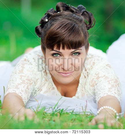 The bride is on the grass
