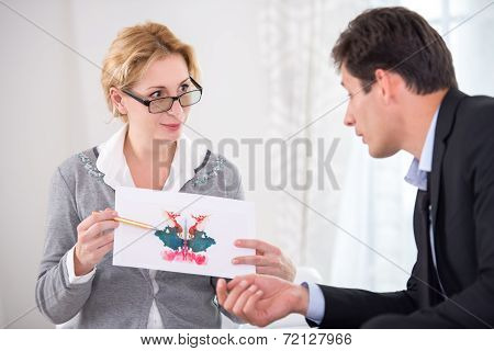 Female psychotherapist holding Rorschach Test