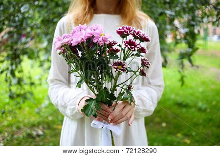 Girl with flowers in hands