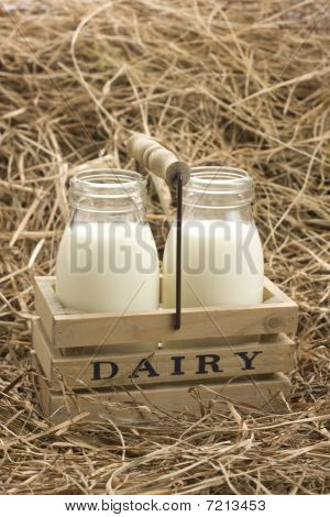 Fresh milk from dairy on haystack