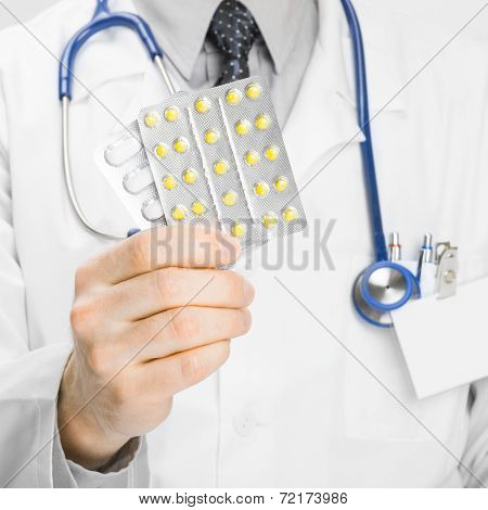Doctor Holdling Pills In His Hand