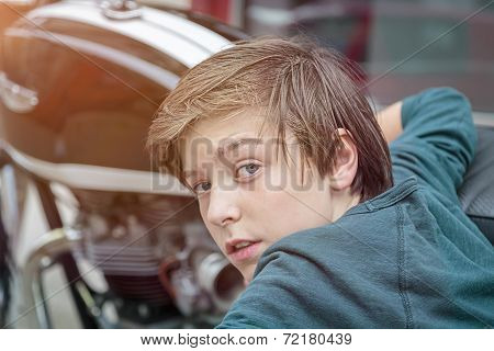Cool Teenager Boy Is Leaning Against A Motorcycle