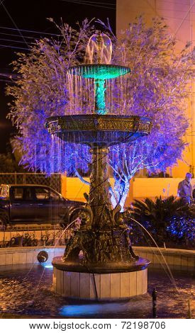 Water fountain lit by colorful lights