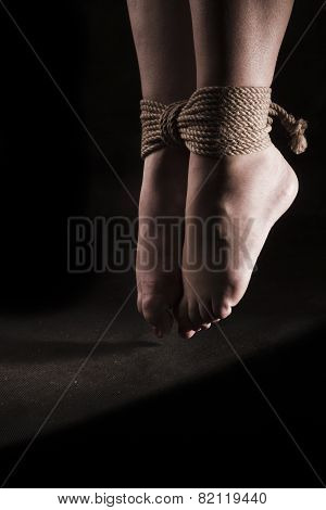 Detail Suspended Bound Feet Submissive Young Girl On A Black Background / Bdsm Theme