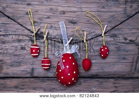 Many Red Easter Eggs And One Big Egg Hanging On Line