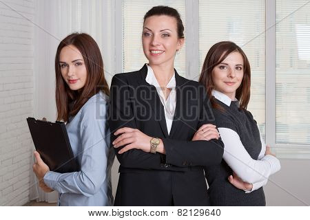 Three Girls In Formal Clothes Are Of Different Heights