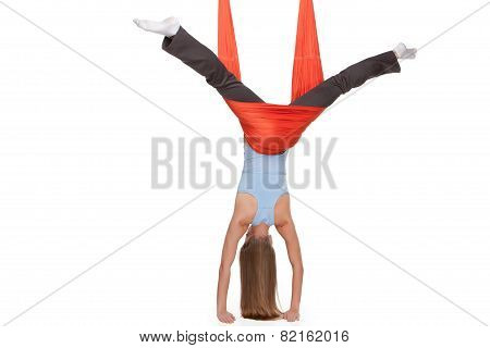 Young woman making antigravity yoga exercises in stretching twine