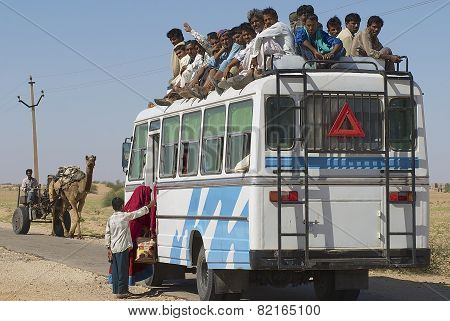 People enter the bus in Jamba, India.