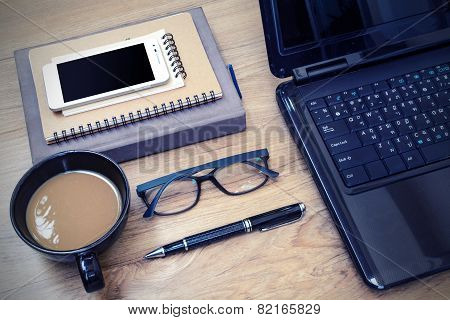 Laptop And Cup Of Coffee With Flower On Desk