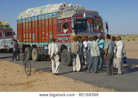 Truck drivers talk on the road in Jamba, India.