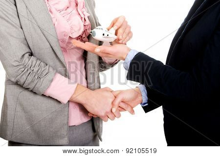 Caucasian businesswoman giving a plane to her partner.