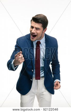 Angry businessman screaming and pointing finger at camera. Isolated on a white background
