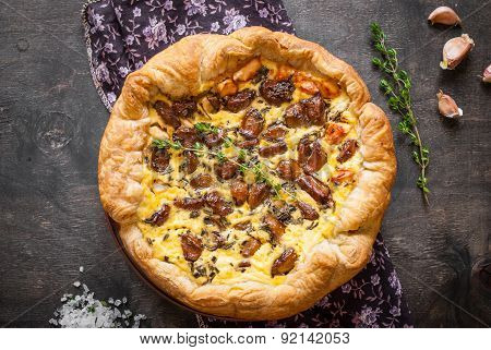 Caramelized Garlic Tart With Goat Cheese On Dark Wooden Background