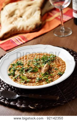 Soup Kharcho, the traditional Georgian soup with meat and rice served with lavash flat bread and wine