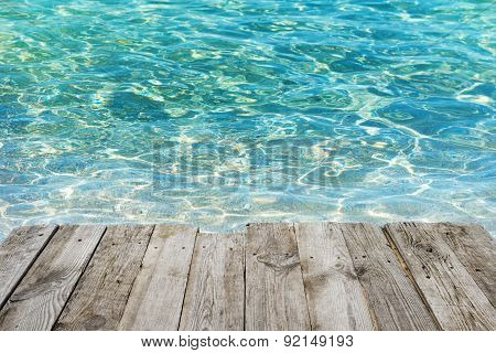 Empty Wooden Table To Tropical Blue Water Background