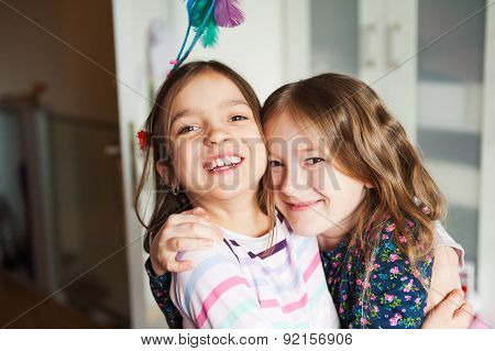 Two little girls playing in their room