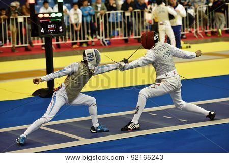 ST. PETERSBURG, RUSSIA - MAY 2, 2015: Erwan Le Pechoux of France vs Haiwei Chen of China in 1/8 final of International fencing tournament St. Petersburg Foil. The tournament is the stage of World Cup