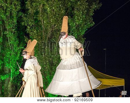 People On Stilts Perform Romeo And Juliet  Wearing Carnival Costumes