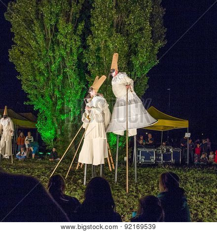 People On Stilts Perform Romeo And Juliet  Wearing Carnival Costumes