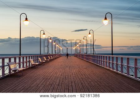 The wooden pier on the sea at sunrise
