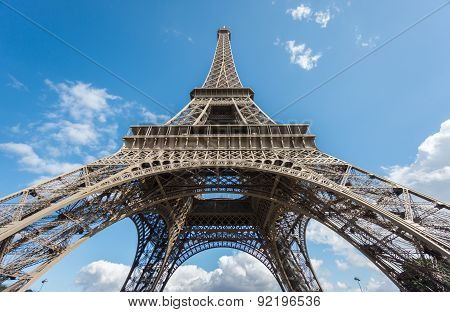 The Eiffel Tower over blue sky, bottom-up view