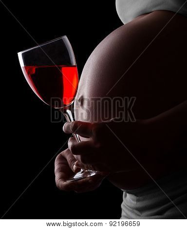 Pregnant woman's belly and wine